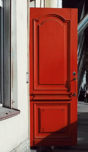 Close-up of closed red door of building