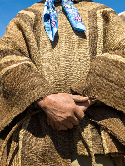 Midsection of man wearing traditional clothing
