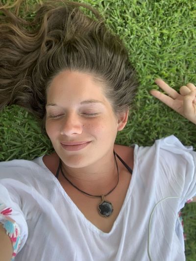Portrait of teenage girl lying on grass