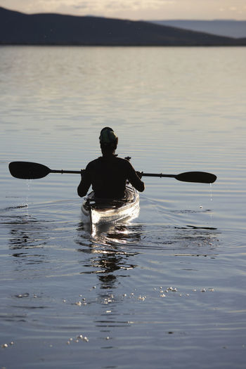 Man enjoying the serenity of lake myvatn on his sea kayak