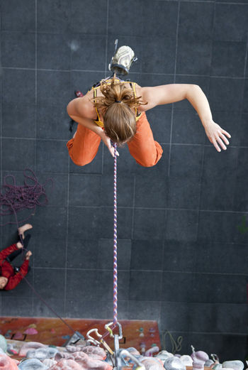 Woman falling off indoor climbing wall