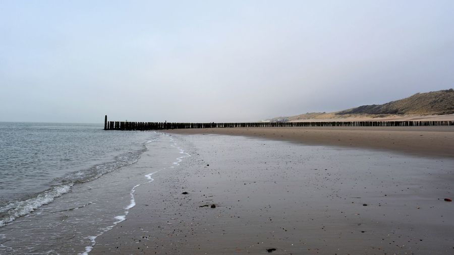 Scenic view of beach against clear sky