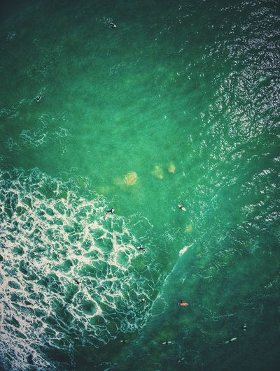 High angle view of surfers on the sea