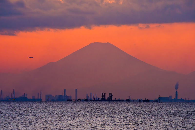 Fuji silhouette over tokyo bay at dusk.