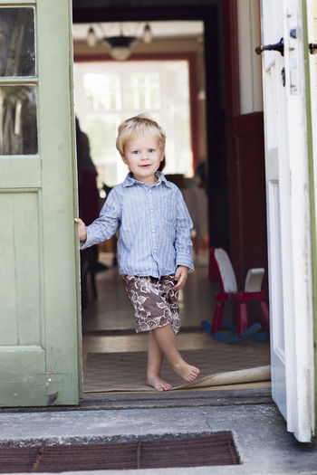 Boy standing in doorway