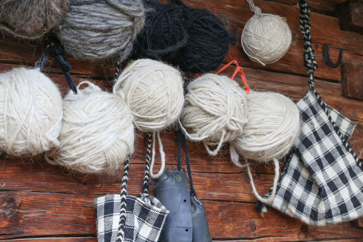 Close-up of wool balls hanging on wooden wall