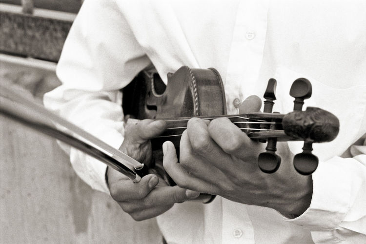 Midsection of man playing violin