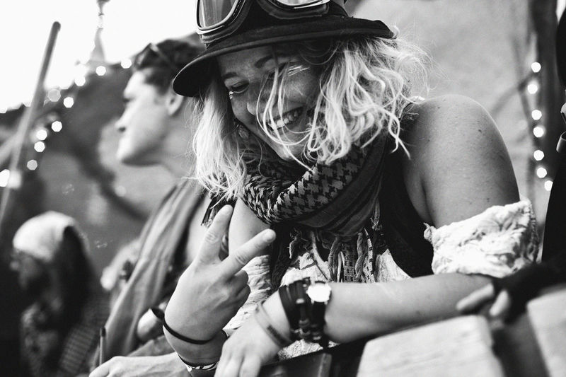 Smiling young woman gesturing peace sign