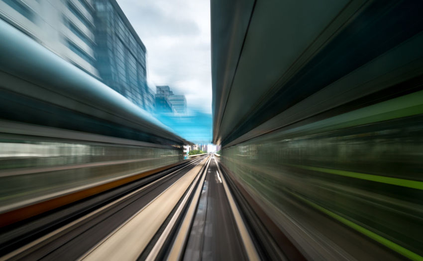Blurred motion of train against building
