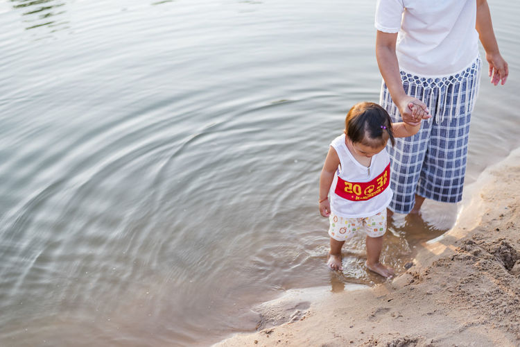 Mother and daughter play on the beach.