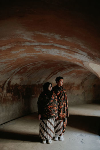 Full length of couple standing in cave