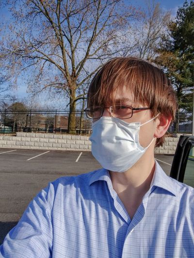 Employee wearing face mask arrives at work