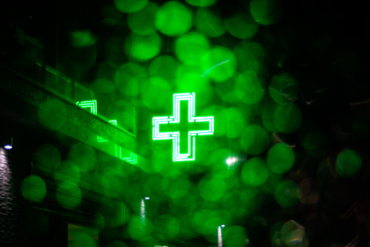 Close-up of illuminated sign against blurred background