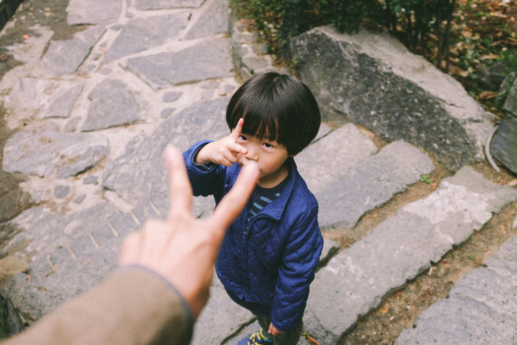 High angle view of boy gesturing