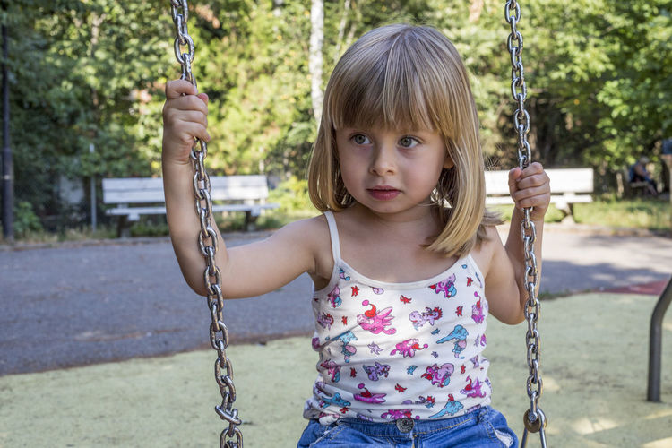 Portrait of girl on swing at the playground
