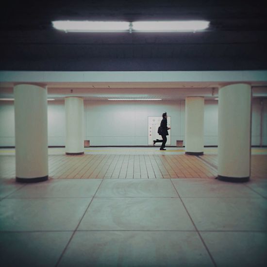 Side view of man running in subway