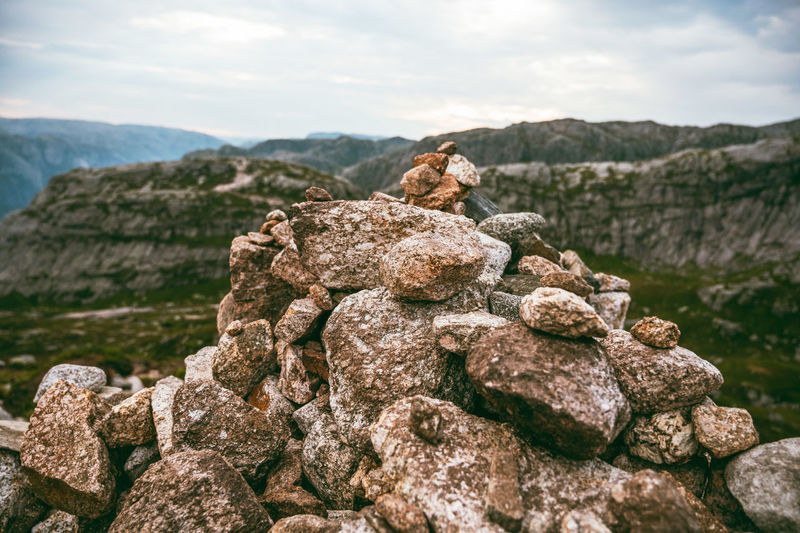 Stack of rocks against mountain against sky