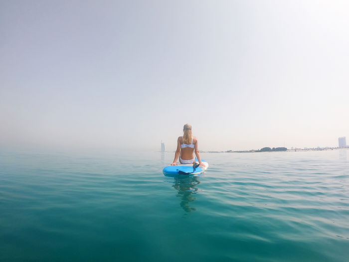 Woman sitting on the paddle board with a view on burj al arab