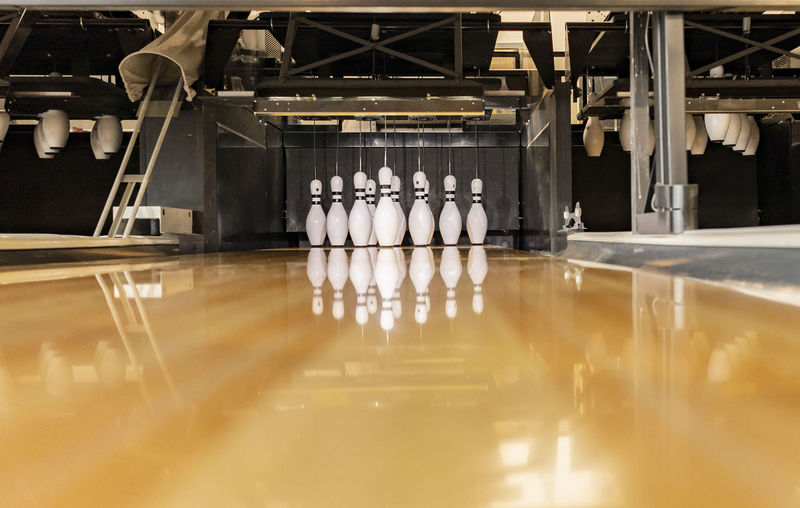 Bowling pins arranged on track at alley
