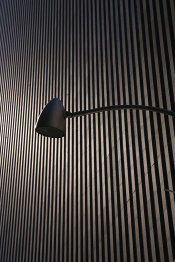 Low angle view of street light against wall