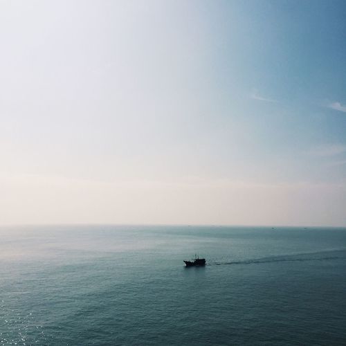 Lone boat in calm blue sea