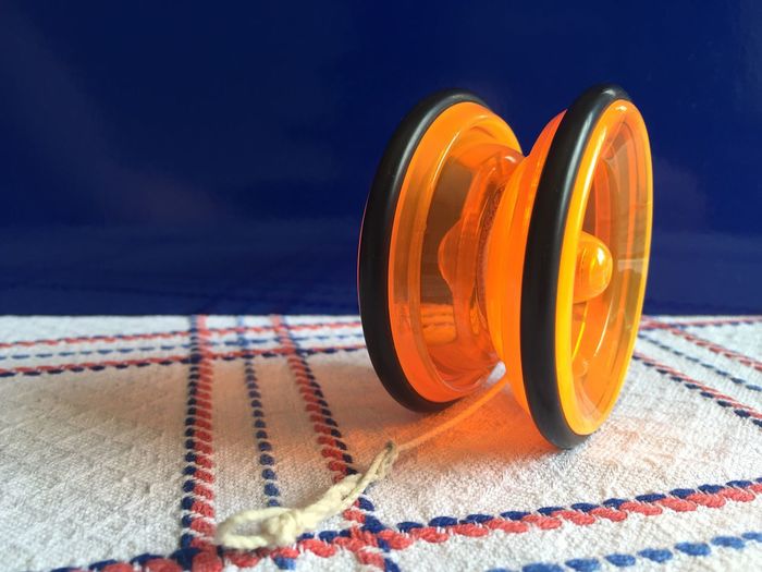 Close-up of orange yo-yo toy on table