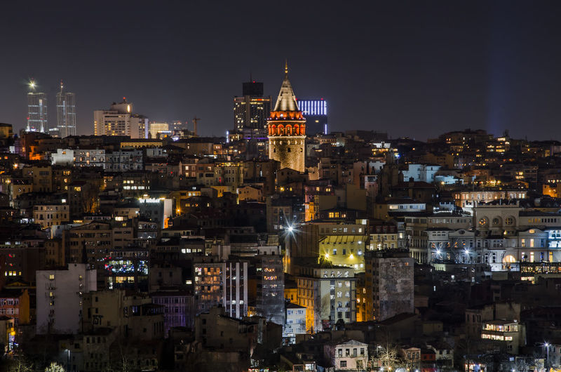 Illuminated galata tower in city at night