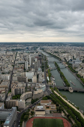 High angle view of river amidst buildings in city against sky