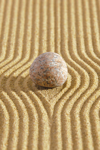 Japanese zen garden with stacked stones in textured  sand