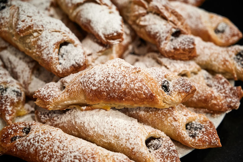 Delicious beautiful tubes with raisins sprinkled with powdered sugar
