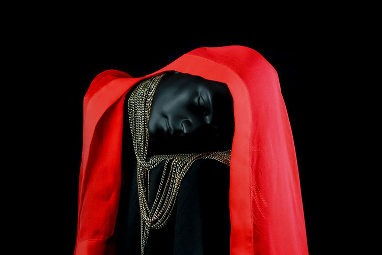 Close-up of mannequin against black background
