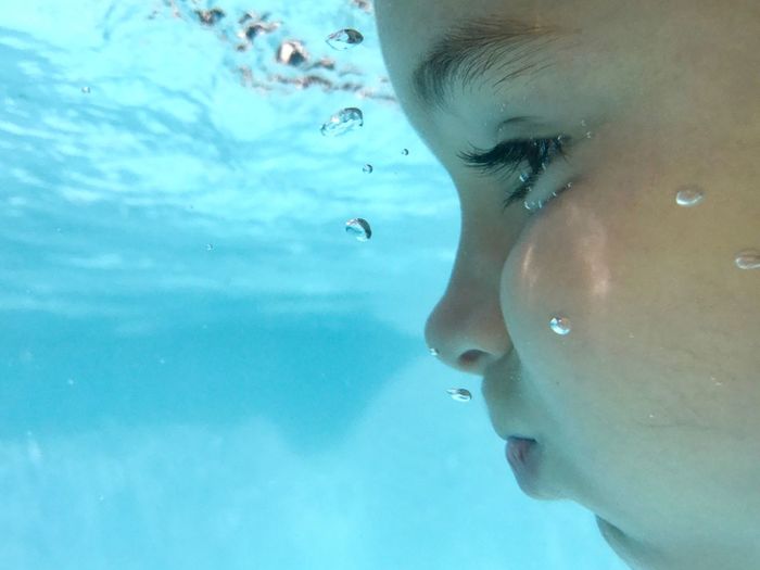 Close-up of girl swimming in water