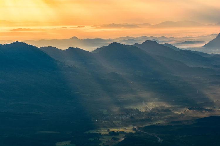 Scenic view of mountains against sky during sunset
