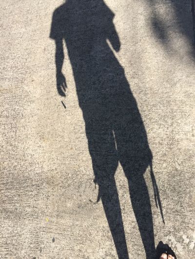 Shadow of person on road