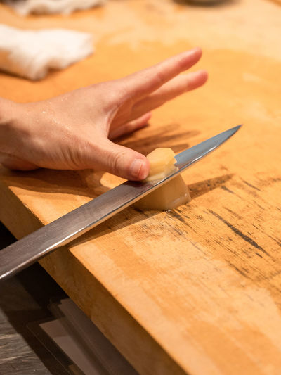Cropped hand of man working on table