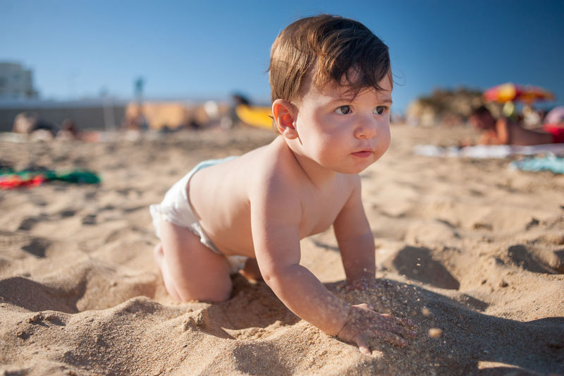 Cute boy on sand at beach
