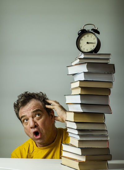 Portrait of a man with books on table