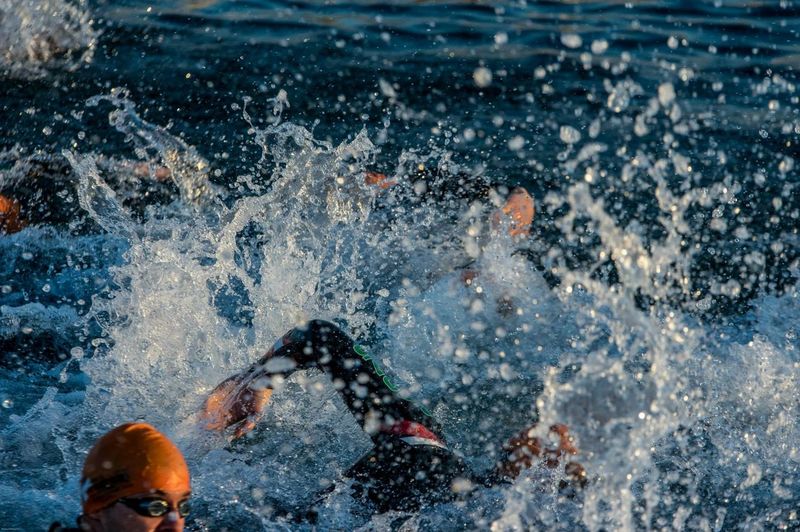 Triathletes swimming in race
