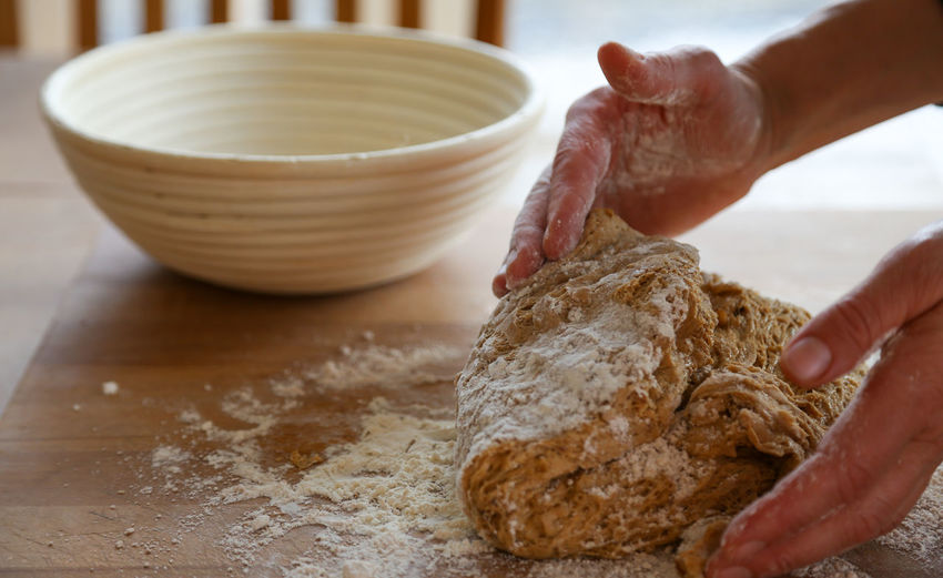 Close-up of person preparing bread dough 