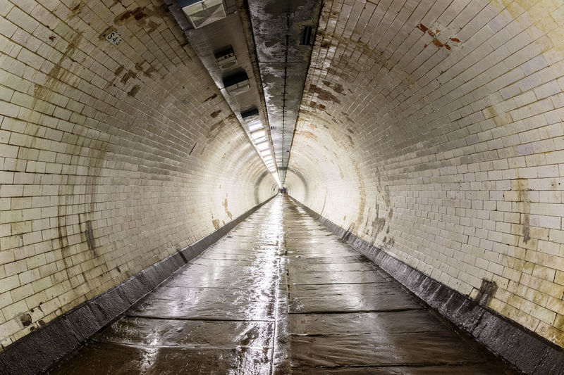The greenwich foot tunnel crosses beneath the river thames in london