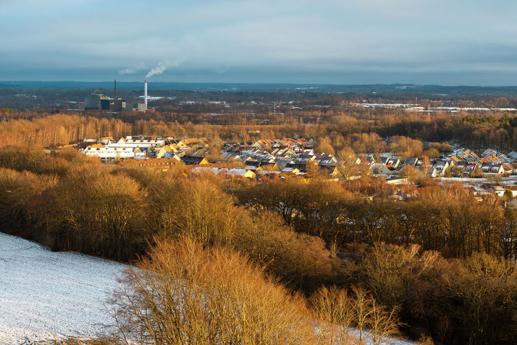 Aerial view of buildings against sky during winter
