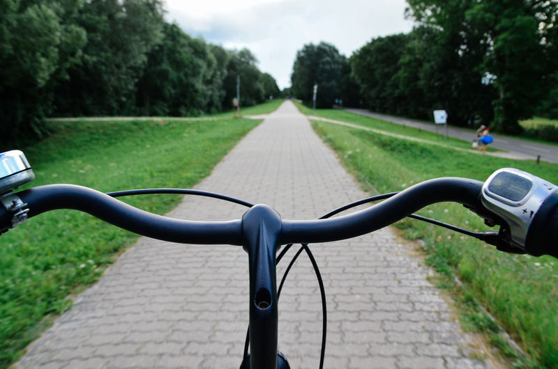 Close-up cropped bicycle handlebar at pathway