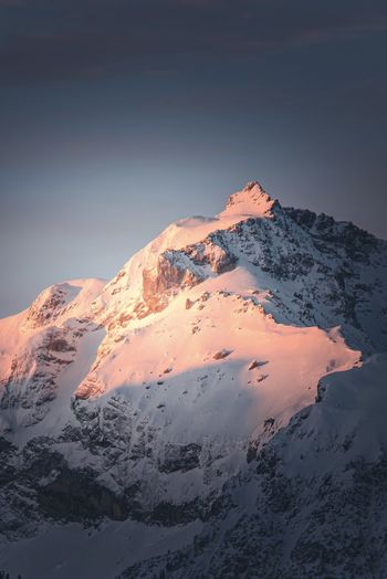 Scenic view of snowcapped mountains against sky during winter