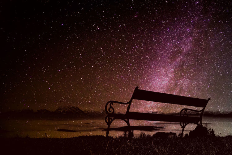 Low angle view of bench on the top of a mountain against a beatiful sky at night. time to think