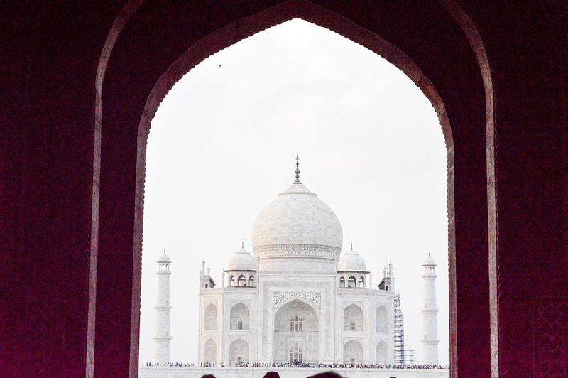 Taj mahal against clear sky seen through arch