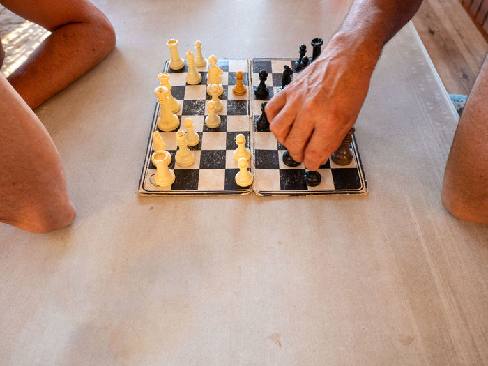 High angle view of people playing chess on table