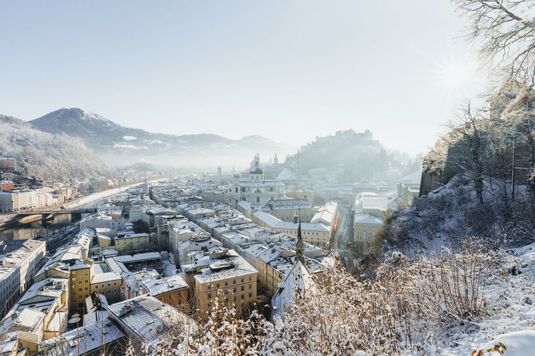 Historic centre of the city of salzburg covered in snow on a beautiful winter day