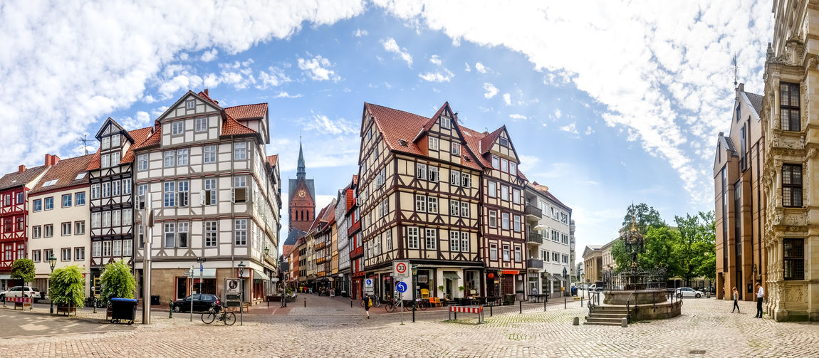 Street and buildings in city against sky