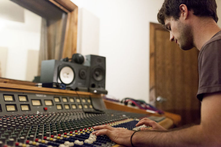 Audio engineer working at mixing board
