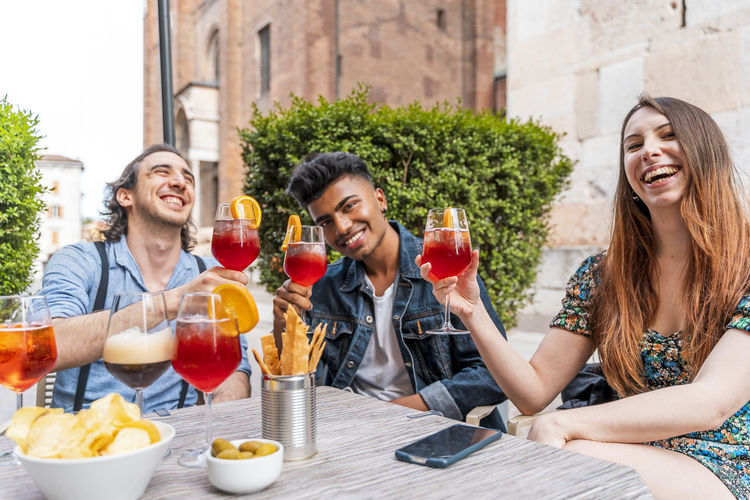 Portrait of friends holding drinks